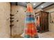 Bathroom with tiled shower and rustic wooden cabinet at 56444 N Vulture Mine Rd, Wickenburg, AZ 85390