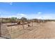 Row of individual horse stalls with shade structures at 56444 N Vulture Mine Rd, Wickenburg, AZ 85390