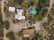 Aerial view of a property with two houses, a pool, and desert landscape at 56444 N Vulture Mine Rd, Wickenburg, AZ 85390