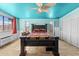 Bright bedroom featuring a wooden bed frame and terracotta flooring at 56444 N Vulture Mine Rd, Wickenburg, AZ 85390