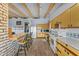 Bright kitchen featuring wood cabinets, tile countertops, and a breakfast bar at 56444 N Vulture Mine Rd, Wickenburg, AZ 85390