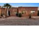 Red brick home with a landscaped yard and a spacious patio at 56444 N Vulture Mine Rd, Wickenburg, AZ 85390