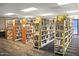Well-lit library with numerous bookshelves filled with various books at 1509 E Peach Tree Dr, Chandler, AZ 85249