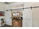 Open kitchen view through barn doors, featuring modern appliances and island at 1509 E Peach Tree Dr, Chandler, AZ 85249