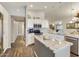 Modern kitchen with a large island, stainless steel appliances and wood floors at 1509 E Peach Tree Dr, Chandler, AZ 85249