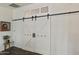 White barn doors with black accents create a stylish room divider at 1509 E Peach Tree Dr, Chandler, AZ 85249