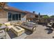 Relaxing backyard patio with seating area, fire pit, and modern decor at 1509 E Peach Tree Dr, Chandler, AZ 85249