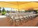 Covered outdoor seating area with numerous chairs at 1509 E Peach Tree Dr, Chandler, AZ 85249