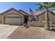 Single story home with a two-car garage and desert landscaping at 1509 E Peach Tree Dr, Chandler, AZ 85249