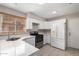 Modern kitchen with white cabinets, stainless steel appliances, and quartz countertops at 2737 S 156Th Ave, Goodyear, AZ 85338