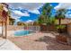 Landscaped backyard with a swimming pool and fire pit at 2737 S 156Th Ave, Goodyear, AZ 85338