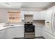 Modern kitchen with white cabinets, stainless steel appliances, and quartz countertops at 2737 S 156Th Ave, Goodyear, AZ 85338