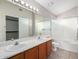 Bathroom boasts double sinks, a bathtub, and a mirrored vanity at 2737 S 156Th Ave, Goodyear, AZ 85338