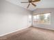 Spacious bedroom with large window and ceiling fan at 2737 S 156Th Ave, Goodyear, AZ 85338