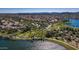Aerial view of a lakefront community showcasing homes and green spaces at 18211 W Sequoia Dr, Goodyear, AZ 85338