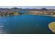 Aerial view of lake, homes, and mountain backdrop at 18211 W Sequoia Dr, Goodyear, AZ 85338
