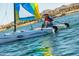 Person sailing Hobie Wave catamaran on lake at 18211 W Sequoia Dr, Goodyear, AZ 85338