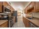 Modern kitchen with stainless steel appliances and wood cabinets at 13409 W Copperstone Dr, Sun City West, AZ 85375