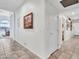 Bright and spacious hallway with tile flooring and access to other rooms at 15802 W Avalon Dr, Goodyear, AZ 85395