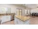 Kitchen island with granite countertops and white cabinetry at 21623 N Gibson Dr, Maricopa, AZ 85139