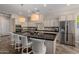 Spacious kitchen boasts a large island with granite countertops and stainless steel appliances at 18211 W Sequoia Dr, Goodyear, AZ 85338