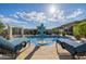 Pool area with lounge chairs and umbrella at 18211 W Sequoia Dr, Goodyear, AZ 85338