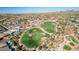 Aerial view showcasing a golf course and surrounding houses in a residential area at 18211 W Sequoia Dr, Goodyear, AZ 85338