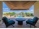Relaxing covered patio with fire pit and pool view at 18211 W Sequoia Dr, Goodyear, AZ 85338