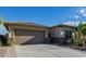Single-story home with a two-car garage and desert landscaping at 18211 W Sequoia Dr, Goodyear, AZ 85338