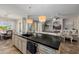 Open kitchen with an island that overlooks the living room at 18211 W Sequoia Dr, Goodyear, AZ 85338