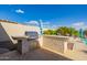Built-in outdoor kitchen with grill and bar top at 18211 W Sequoia Dr, Goodyear, AZ 85338