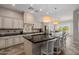 Open concept kitchen with island, granite countertops, and plenty of cabinet space at 18211 W Sequoia Dr, Goodyear, AZ 85338