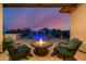Covered patio with fire pit and view of the pool at 18211 W Sequoia Dr, Goodyear, AZ 85338