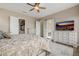 Spacious bedroom with ensuite bathroom access and TV at 18211 W Sequoia Dr, Goodyear, AZ 85338