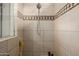 Walk-in shower with tiled surround and built-in seat at 18211 W Sequoia Dr, Goodyear, AZ 85338