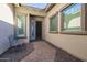 Front entry with a courtyard, brick walkway, and wrought-iron bench at 18211 W Sequoia Dr, Goodyear, AZ 85338
