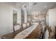 Bright dining room with a large wooden table and access to the kitchen at 18211 W Sequoia Dr, Goodyear, AZ 85338