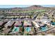 Aerial view of neighborhood featuring multiple homes with pools and golf course at 18211 W Sequoia Dr, Goodyear, AZ 85338