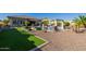 Landscaped backyard with a pool and artificial turf at 18211 W Sequoia Dr, Goodyear, AZ 85338