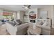 Living room with fireplace, built-in shelving, and access to backyard at 18211 W Sequoia Dr, Goodyear, AZ 85338