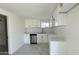 Modern kitchen with white cabinets, gold hardware, quartz countertops, and stainless steel appliances at 568 N Sirrine --, Mesa, AZ 85201