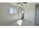 Bright bedroom with tile floors and a door to hallway at 568 N Sirrine --, Mesa, AZ 85201