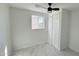 Bright bedroom with large window, ceiling fan, and tile floors at 568 N Sirrine --, Mesa, AZ 85201