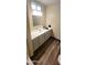 Bathroom with vanity, mirror, and wood-look flooring at 120 N Val Vista Dr # 86, Mesa, AZ 85213