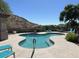 Relaxing kidney-shaped pool with surrounding patio and lounge chairs at 3236 E Chandler Blvd # 1033, Phoenix, AZ 85048