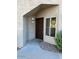 Inviting condo entryway with a brown door and window at 3236 E Chandler Blvd # 1033, Phoenix, AZ 85048