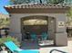 Relaxing pool area with covered seating and a table at 3236 E Chandler Blvd # 1033, Phoenix, AZ 85048