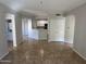 Open living room with tile floors and kitchen bar at 3236 E Chandler Blvd # 1033, Phoenix, AZ 85048