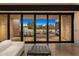 View of the backyard through large sliding glass doors from the comfort of a white couch inside at 7501 E Palo Verde Dr # 8, Scottsdale, AZ 85250