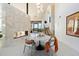 Modern dining area with fireplace, unique light fixture, and desert views at 9701 E Happy Valley Rd # 10, Scottsdale, AZ 85255